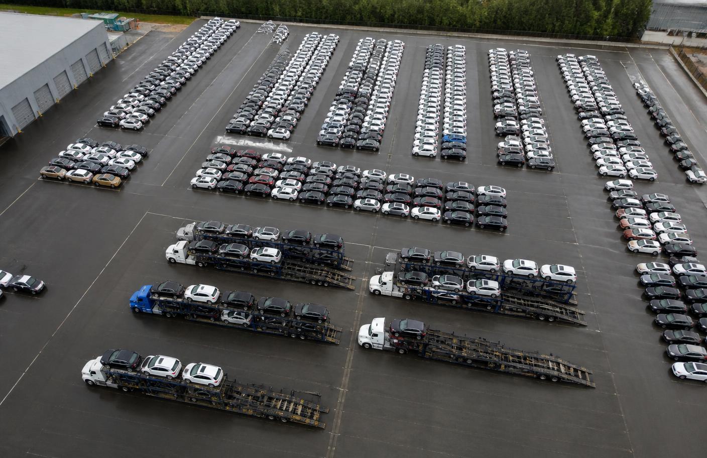 Aerial view of an auto logistics terminal yard with staged vehicles and haulers